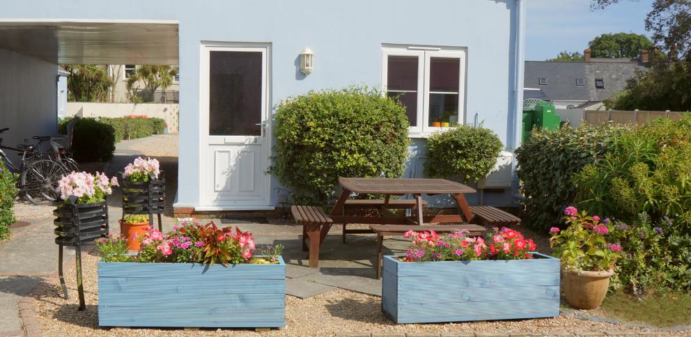 small patio area screened with blue planters