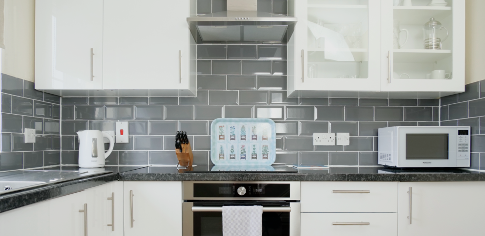 white kitchen with grey subway tiles.