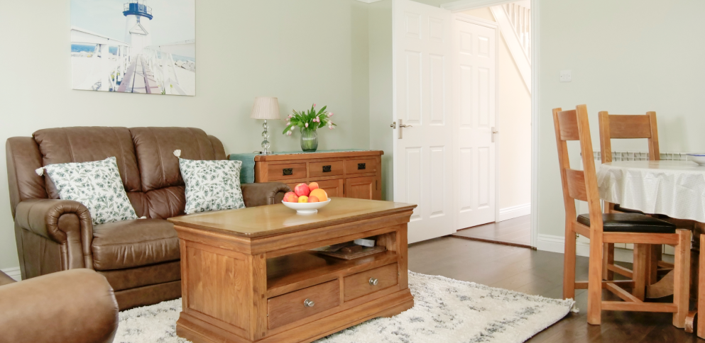 living room with stylish dark floorboards, a shaggy rug and quality oak furniture