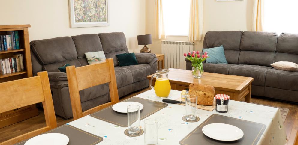 table set for dinner in a large living room/dining room