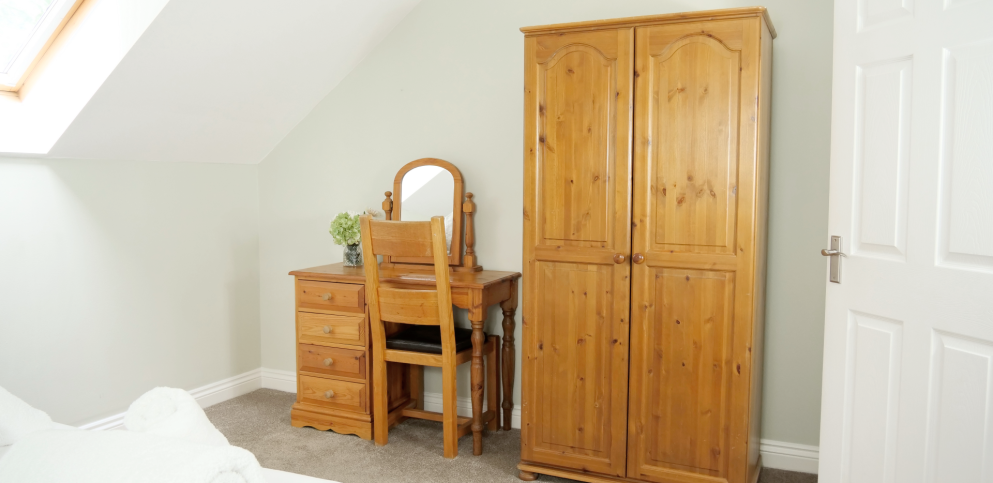 pine wardrobe and pine desk in bedroom