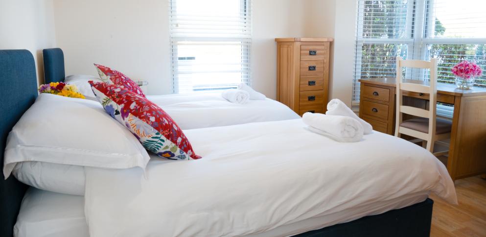 twin beds with red cushions